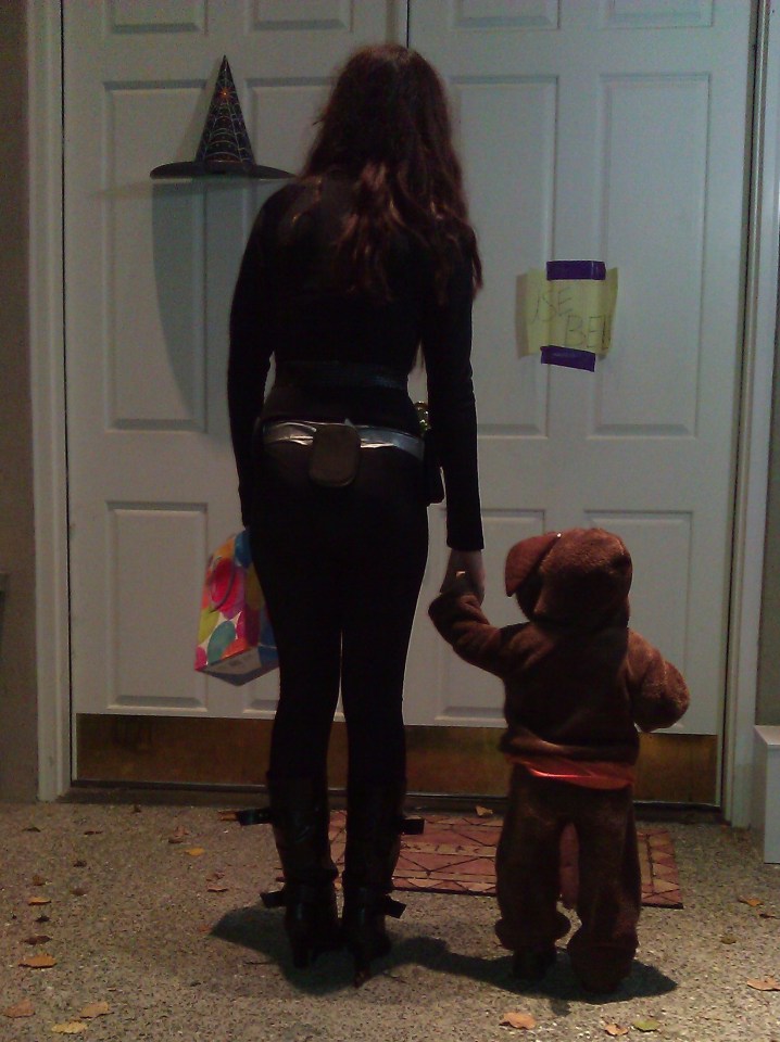 photo of teen and toddler trick or treating