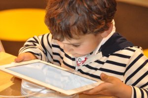 a child looking at a mobile device